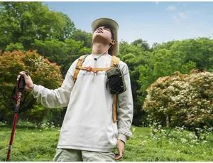 Outdoor hiking shoulder strap pouch detailed view in a natural green forest scenery.