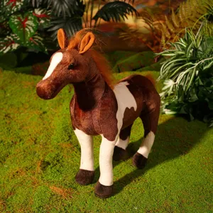 Close-up detail of the brown and white plush horse toy displayed on a mossy background.