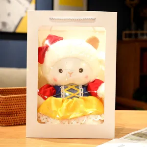 Cute sheep plush toy wearing princess dress inside gift bag with fairy lights for birthday gift.