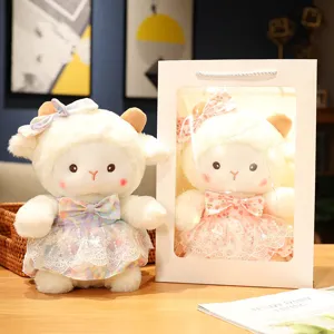 Cute plush sheep toy detail view showcasing soft fabric dress and gift box with fairy lights.