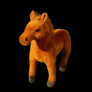 Detailed close-up of a brown plush horse toy, soft fabric, cute stuffed animal detail.