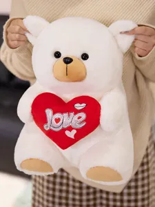 White plush teddy bear holding red heart with love embroidery, cute soft stuffed animal toy gift.
