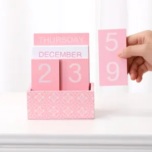 Wooden perpetual desk calendar with pink blocks, date and month display for office decor.