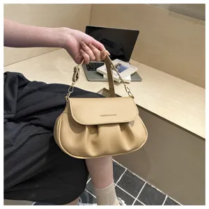 Beige ruched shoulder bag detail, elegant saddle bag design with metallic strap buckle.