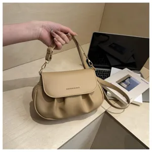 Khaki ruched shoulder bag detail, elegant pleats and adjustable strap for daily commute style.