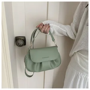 Detailed shot of the light green ruched saddle bag, showcasing the elegant pleats and hardware.