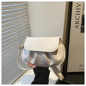 Minimalist pleated white saddle bag for women, stylish shoulder and crossbody bag.