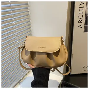 Close-up detail of the stylish pleated women shoulder bag, minimalist khaki saddle design.