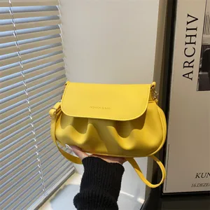 Stylish yellow pleated shoulder bag for women, trendy PU leather crossbody saddle bag with strap.