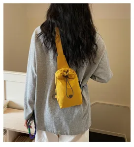Yellow drawstring crossbody phone bag, casual canvas sling bag for daily commute and travel.