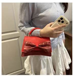 Red bow handbag for women, elegant shoulder crossbody bag with stylish bowknot design.