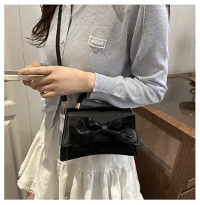 Chic black shoulder bag for women, elegant bowknot design, versatile crossbody handbag.