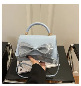 Light blue bow handbag detail, stylish PU leather crossbody bag, elegant women shoulder bag.