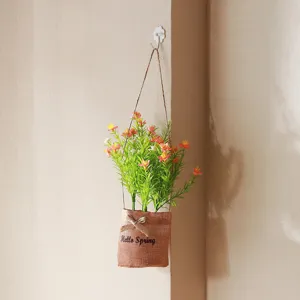 Nordic style artificial flower hanging plant with burlap bag pot for home indoor decor.