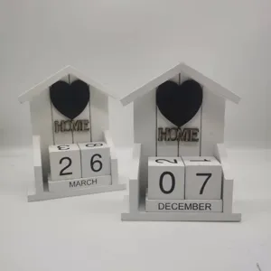 Wooden perpetual calendar desk decoration with house shape, black heart and date blocks.