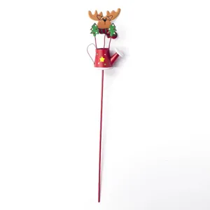 Christmas metal garden stake detail shot, red watering can with cute reindeer topper design.
