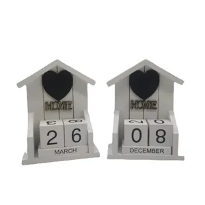 Wooden perpetual calendar desktop ornament with house shape, black heart decor and date blocks.