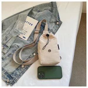 Minimalist beige drawstring crossbody phone bag, casual solid color shoulder bag for daily commute.
