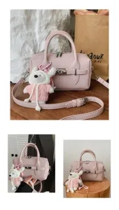 Detalle de bolso rosa con grano lichi que muestra textura, herrajes y lindo colgante de peluche.
