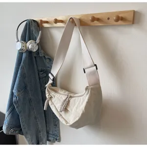Casual dumpling crossbody bag for women, simple stylish commuter shoulder bag with wide strap.