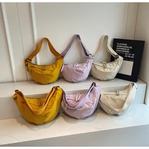 Casual nylon dumpling crossbody bag showcasing multiple colors and adjustable shoulder straps.