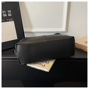 Black shoulder bag detail view, simple PU leather design for daily commute and casual use.