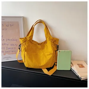 Casual nylon shoulder bag for women, large capacity waterproof crossbody bag, solid yellow.
