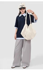 Detailed shot of casual beige quilted tote bag, large capacity canvas shoulder bag for daily use.