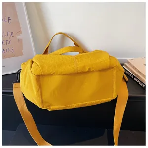 Solid color nylon crossbody bag, casual lightweight shoulder bag with top handle and strap.