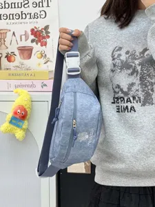 Casual denim fanny pack with adjustable strap and front zipper pocket for outdoor travel use.