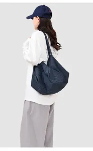 Detailed view of the casual plaid tote bag, featuring large capacity and comfortable strap.