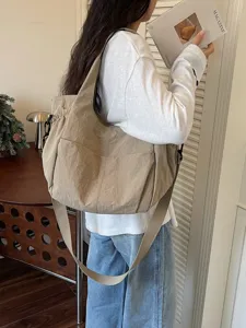 Casual nylon shoulder crossbody bag with large capacity, worn by model for daily wear.