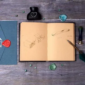 Vintage kraft paper notebook with sketches and vintage stationery props for diary and art journaling.