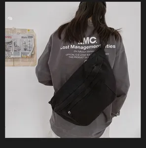 Retro casual black canvas chest bag, large capacity streetwear crossbody bag for daily use.
