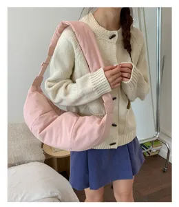 Detalle de bolso de hombro rosa elegante, diseño cruzado acolchado casual para uso diario.
