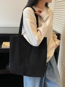 Minimalist black corduroy tote bag large capacity casual shoulder bag for women daily commuting.