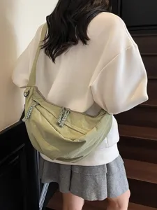 Casual commuter dumpling shoulder bag for women, stylish crossbody bag in light green tone.