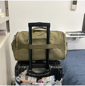 Large capacity waterproof canvas travel duffel bag with trolley sleeve and strap.