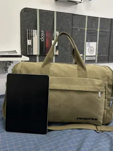 Large capacity waterproof canvas travel duffel bag with shoulder strap and convenient handles.
