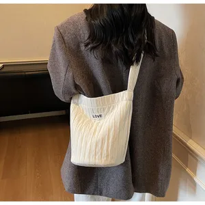 Casual pleated white shoulder bag detail view, large capacity versatile crossbody handbag.