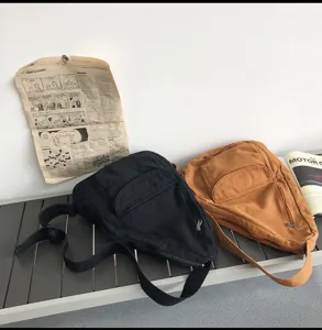 Sac bandoulière en toile style vintage, vue détaillée du sac de poitrine zippé pratique.