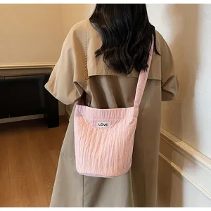 Detailed view of the trendy pink pleated shoulder bag highlighting texture and design.