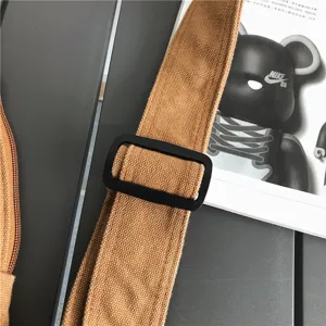 Détail de sangle de sac de poitrine en toile, boucle métallique réglable, style rétro.