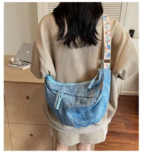 Casual street style denim crossbody bag with colorful strap and large capacity design.