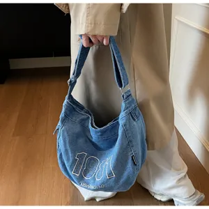 Retro denim shoulder bag detail, casual vintage style with embroidered numbers and large capacity.