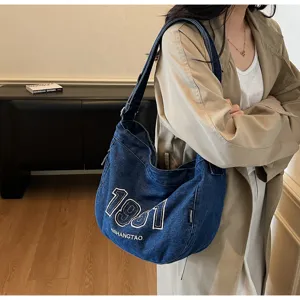 Retro denim shoulder bag detail shot, casual hobo design with embroidery, large capacity.