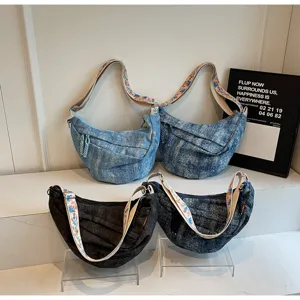Casual denim crossbody bag with floral strap, stylish crescent sling bag for daily streetwear.