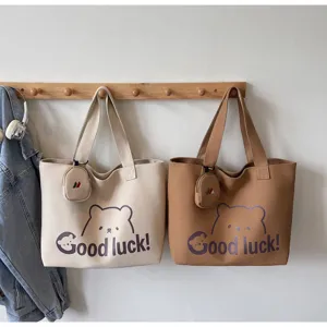 Large capacity canvas tote bag for women, casual shoulder bag with cute bear and letters.