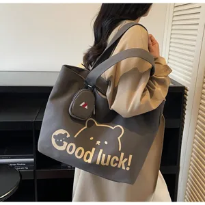 Detailed view of the large capacity grey canvas tote bag with cute bear print and shoulder straps.