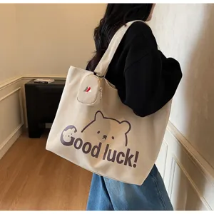 Casual canvas tote bag with cute bear print and large capacity for daily student commute and travel.